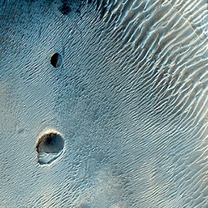 Dark-Toned, Pitted Mound in a Crater in Northeast Arabia Terra